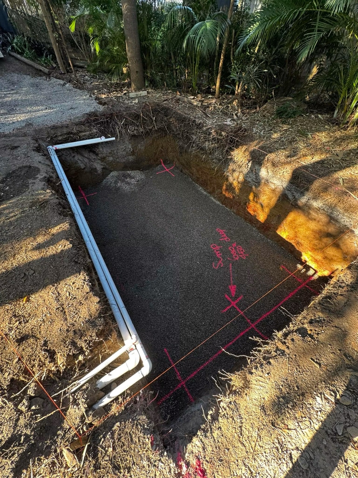 Prepared excavation base with drainage installed